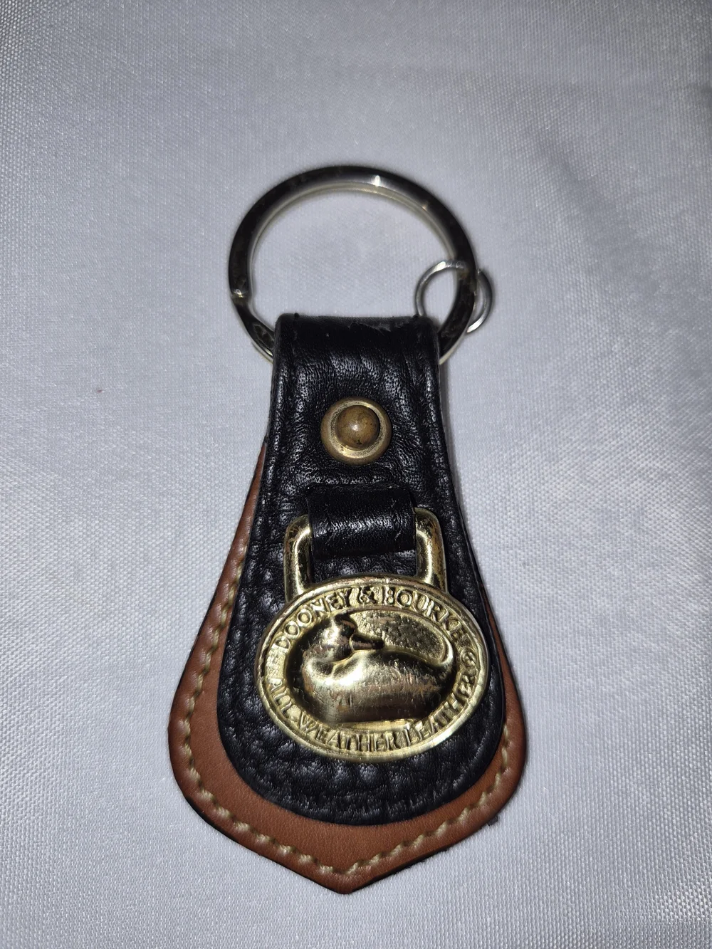 Dooney & Bourke Black and Brown Leather Key Fob with Brass Medallion